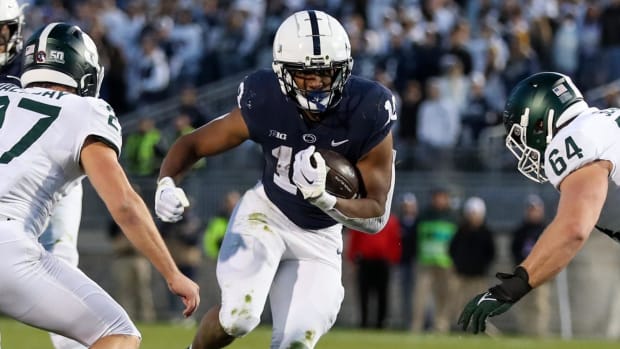Penn State Nittany Lions running back Nicholas Singleton on a rushing attempt during a Big Ten college football game.