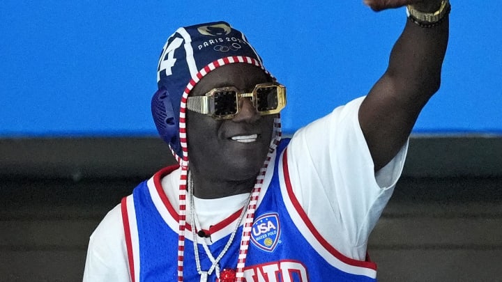 Jul 27, 2024; Paris, France; Recording artist Flavor Flav waves to the crowd during the match between Greece and United States of America in women’s water polo group B play during the Paris 2024 Olympic Summer Games at Aquatics Centre. 