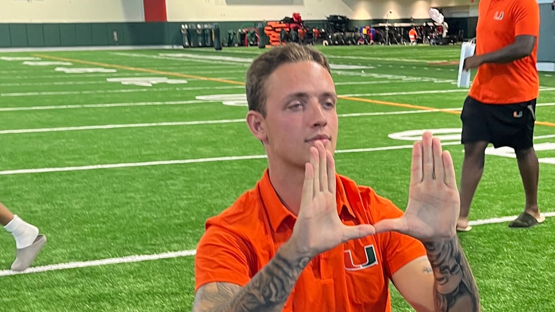 Carson Beck Holding Up the U during Miami's Fall Camp Media Day