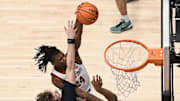 Jan 11, 2025; Stanford, California, USA; Stanford Cardinal forward Jaylen Thompson (24) dunks over Virginia Cavaliers forward Anthony Robinson (21) and forward TJ Power (23) in the second half at Maples Pavilion. Mandatory Credit: Eakin Howard-Imagn Images