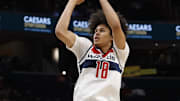 Dec 6, 2025; Washington, District of Columbia, USA; Washington Wizards forward Kyshawn George (18) shoots the ball as Atlanta Hawks guard Dyson Daniels (5) defends in the first half at Capital One Arena. Mandatory Credit: Geoff Burke-Imagn Images