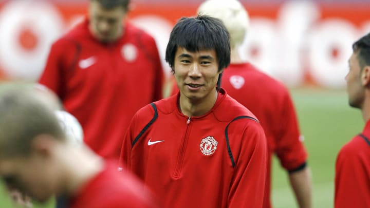 Manchester United's Fangzhuo Dong (C) sm...
