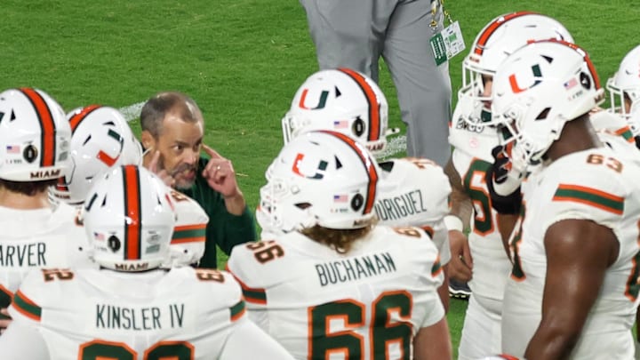 Jan 19, 2026; Miami Gardens, FL, USA; Miami Hurricanes head coach Mario Cristobal speaks to his players during warmups prior to the College Football Playoff National Championship game against the Indiana Hoosiers at Hard Rock Stadium. Mandatory Credit: Kim Klement Neitzel-Imagn Images