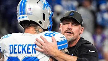 Detroit Lions head coach Dan Campbell hugs offensive tackle Taylor Decker (68) during warmup before the Dallas Cowboys game 