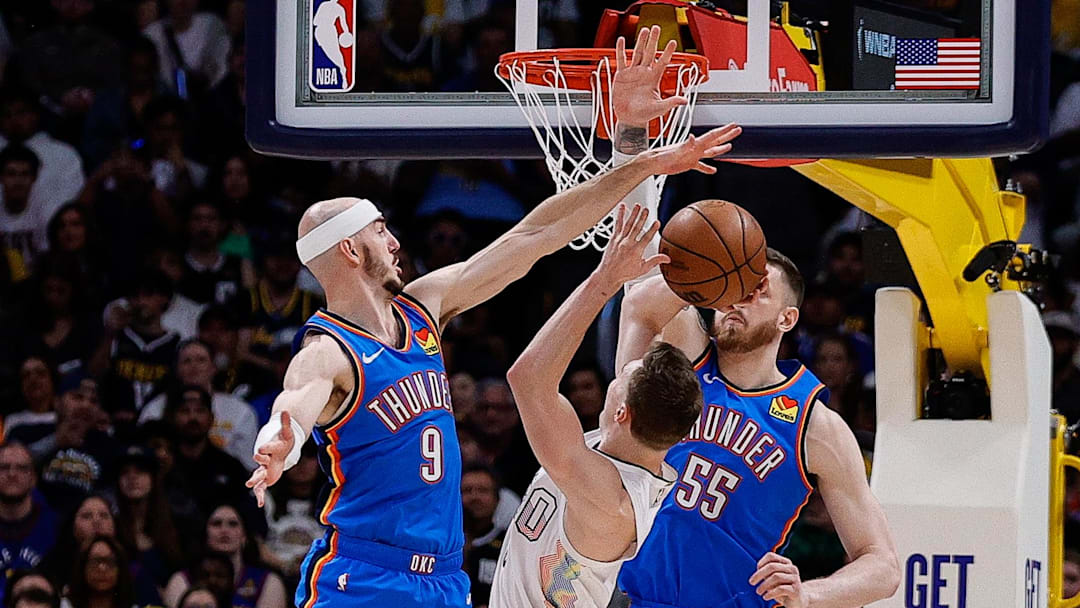 May 15, 2025; Denver, Colorado, USA; Denver Nuggets guard Christian Braun (0) attempts a shot under pressure from Oklahoma City Thunder guard Alex Caruso (9) and center Isaiah Hartenstein (55) in the second quarter during game six of the second round for the 2025 NBA Playoffs at Ball Arena.
