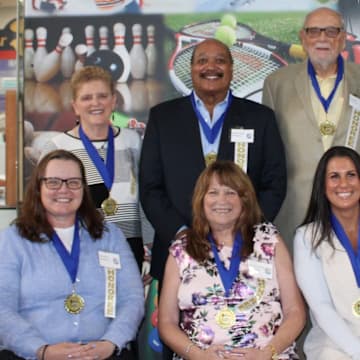 Representatives from the Greater Syracuse Sports of Hall of Fame recently announced its Class of 2025 inductees, which includes a handful of former high school standouts. In the front row, from left, are Chris Lindsey, Kim Sharpe Green and Brittany Brigandi. In the back row, from left, are Buddy Hardeman, Bill Sanford and Frank Riccelli.