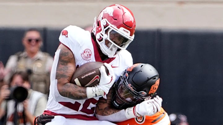 Oklahoma State's Nick Martin (4) tackles Arkansas Razorbacks running back Ja'Quinden Jackson (22) at Boone Pickens Stadium in Stillwater, Okla.