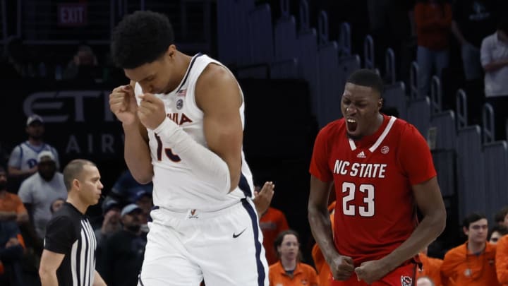 Mar 15, 2024; Washington, D.C., USA; North Carolina State Wolfpack forward Mohamed Diarra (23) and Virginia Cavaliers guard Ryan Dunn (13) react on the court in the final minute of overtime at Capital One Arena. Mandatory Credit: Geoff Burke-USA TODAY Sports