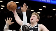 Dec 1, 2025; Brooklyn, New York, USA; Brooklyn Nets forward Danny Wolf (2) dunks against Charlotte Hornets forward Miles Bridges (0) during the fourth quarter at Barclays Center. Mandatory Credit: Brad Penner-Imagn Images