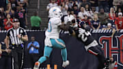 Houston Texans cornerback Derek Stingley intercepts the ball against Miami Dolphins wide receiver Tyreek Hill in an NFL game
