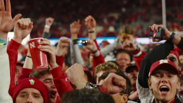 Nebraska fans celebrate on the field after the Huskers' 44-25 win  against Wisconsin on Nov. 23, 2024 in Lincoln.