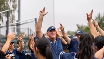 Cal Baptist head softball coach Mike Smith celebrates a win with the rest of his team.