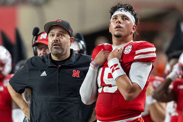 Nebraska Head Coach Matt Rhule and quarterback Dyaln Raiola look up at the scoreboard during the Illinois game.