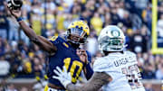 Michigan quarterback Alex Orji (10) makes a pass against Oregon defensive end Matayo Uiagalelei (10) during the first half at Michigan Stadium in Ann Arbor on Saturday, Nov. 2, 2024.