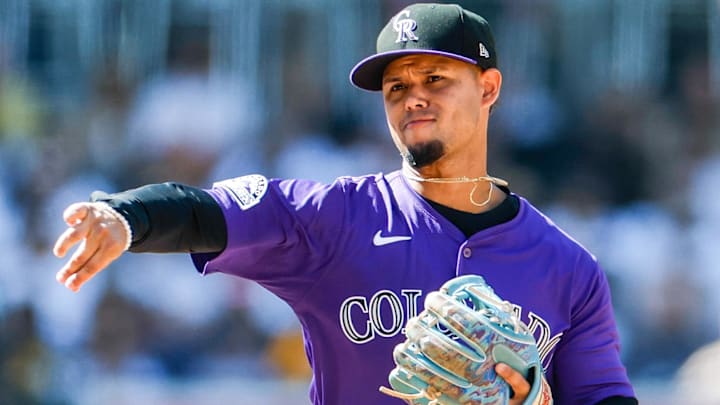 Apr 13, 2025; San Diego, California, USA; Colorado Rockies shortstop Ezequiel Tovar (14) throws to first base to complete the double play during the eighth inning against the San Diego Padres at Petco Park