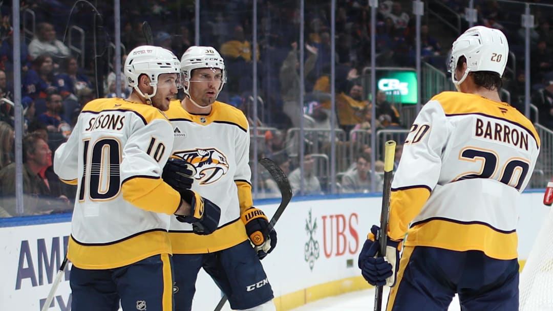 Mar 1, 2025; Elmont, New York, USA;  Nashville Predators left wing Cole Smith (36) celebrates his goal with center Colton Sissons (10) and defenseman Justin Barron (20) against the New York Islanders during the third period at UBS Arena. Mandatory Credit: Thomas Salus-Imagn Images