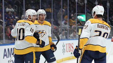 Mar 1, 2025; Elmont, New York, USA;  Nashville Predators left wing Cole Smith (36) celebrates his goal with center Colton Sissons (10) and defenseman Justin Barron (20) against the New York Islanders during the third period at UBS Arena. Mandatory Credit: Thomas Salus-Imagn Images