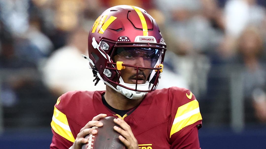 Oct 19, 2025; Arlington, Texas, USA; Washington Commanders quarterback Jayden Daniels (5) looks to pass the ball against the Dallas Cowboys during the first quarter of the game at AT&T Stadium. Mandatory Credit: Kevin Jairaj-Imagn Images