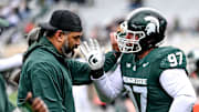 Michigan State's Maverick Hansen, right, works with defensive line coach Legi Suiaunoa during the Spring Showcase on Saturday, April 20, 2024, at Spartan Stadium in East Lansing.