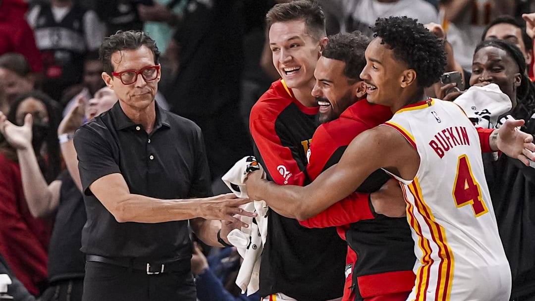 Oct 8, 2024; Atlanta, Georgia, USA; Atlanta Hawks head coach Quin Snyder and guards Vit Krejci (27) Trae Young (11) and Kobe Bufkin (4) react after the Hawks hit a three point shot against the Indiana Pacers with less than a second remaining in the second half at State Farm Arena. Mandatory Credit: Dale Zanine-Imagn Images