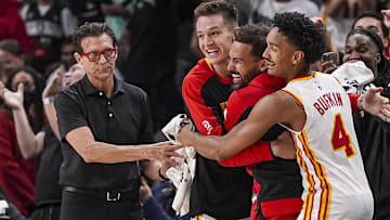 Oct 8, 2024; Atlanta, Georgia, USA; Atlanta Hawks head coach Quin Snyder and guards Vit Krejci (27) Trae Young (11) and Kobe Bufkin (4) react after the Hawks hit a three point shot against the Indiana Pacers with less than a second remaining in the second half at State Farm Arena. Mandatory Credit: Dale Zanine-Imagn Images