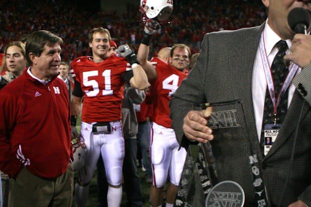 Andy Kadavy raises his helmet and linebacker linebacker Bo Ruud pumps a fist as Nebraska head coach Bill Callahan prepares to
