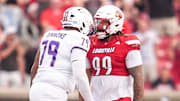 Louisville Cardinals defensive lineman Jordan Guerad (99) has words with James Madison Dukes offensive lineman Joseph Simmons (79) in the first half during the Louisville-James Madison college football game Friday September 5, 2025 at L&N Credit Union Stadium in Louisville, Kentucky.