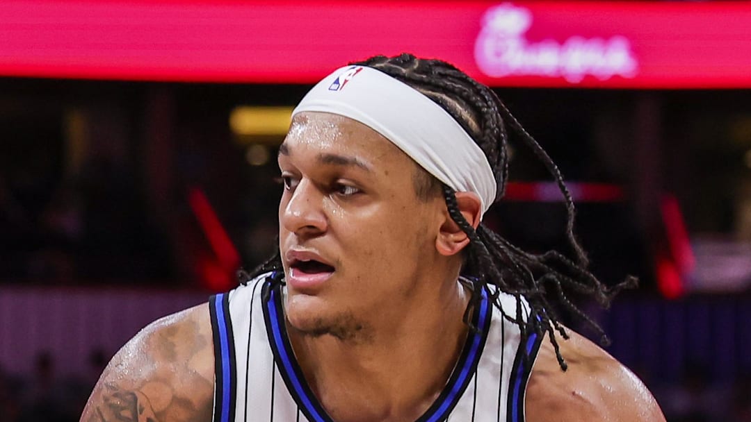 Orlando Magic forward Paolo Banchero drives against Milwaukee Bucks guard AJ Green.