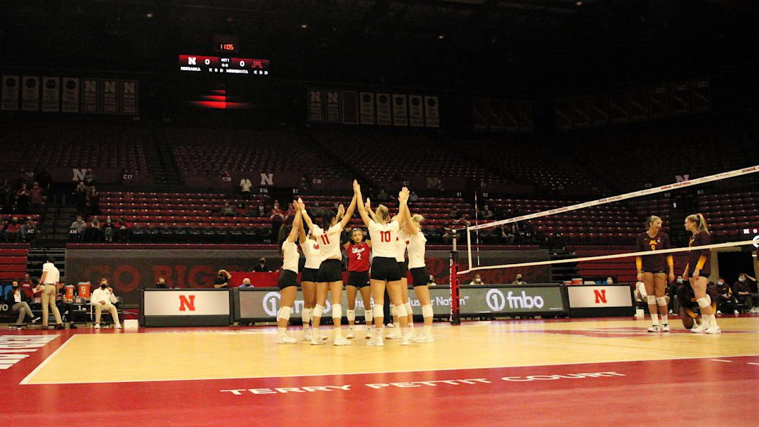 Nebraska huddles before taking on Minnesota at a near-empty Devaney Center during the spring 2021 season. The Huskers played matches in an empty Devaney Center in a season that was delayed by the COVID-19 pandemic. 
