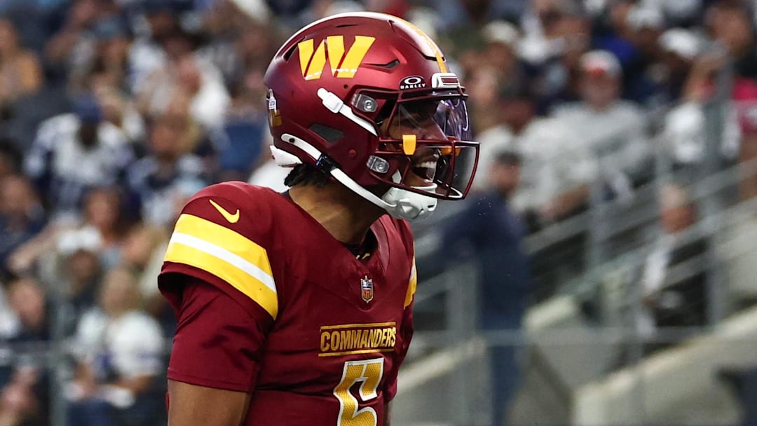 Oct 19, 2025; Arlington, Texas, USA; Washington Commanders quarterback Jayden Daniels (5) celebrates after scoring a touchdown against the Dallas Cowboys during the second quarter of the game at AT&T Stadium. Mandatory Credit: Kevin Jairaj-Imagn Images