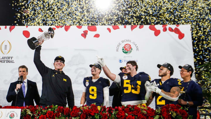 Jan. 1, 2024: Michigan head coach Jim Harbaugh lifts up the Rose Bowl trophy after a 27-20 win over