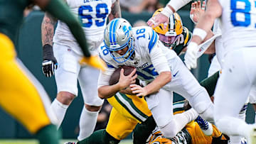 Detroit Lions quarterback Jared Goff is sacked by Green Bay Packers defensive ends Lukas Van Ness (90) and Rashan Gary (52) during the second half at Lambeau Field in Green Bay, Wis., on Sunday, September 7, 2025.
