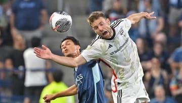 Jul 10, 2024; Kansas City, Kansas, USA;  FC Dallas midfielder Asier Illarramendi (14) heads the ball against Sporting Kansas City forward D·niel Salloi (10) in the first half at Children's Mercy Park. Mandatory Credit: Peter Aiken-USA TODAY Sports