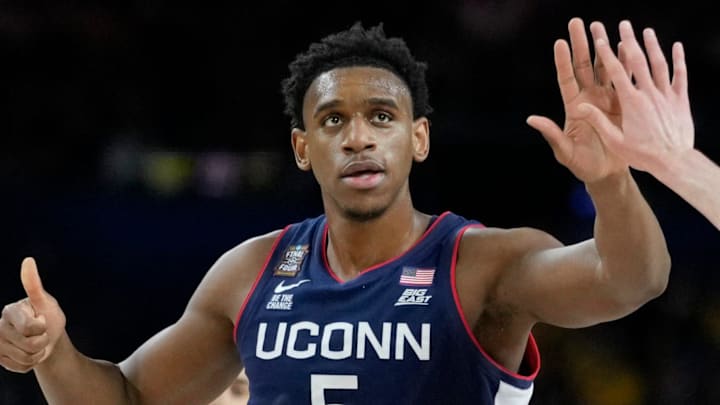UConn Huskies forwards Tarris Reed Jr. (5) and Alex Karaban (11) high five Monday, April 6, 2026, during the NCAA men's basketball tournament national championship game against the Michigan Wolverines at Lucas Oil Stadium in Indianapolis.