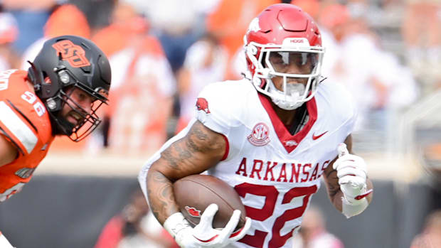 Razorbacks running back Ja'Quinden Jackson tries to get the edge against Oklahoma State's defense