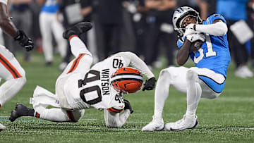 Aug 8, 2025; Charlotte, North Carolina, USA; Carolina Panthers cornerback Corey Thornton (31) tries to keep his balance after being tripped up by Cleveland Browns linebacker Nathaniel Watson (40) during the second half at Bank of America Stadium. Mandatory Credit: Jim Dedmon-Imagn Images