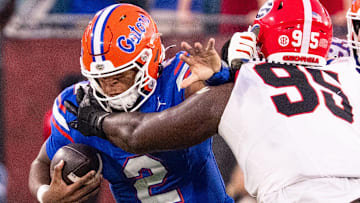 Florida Gators quarterback DJ Lagway (2) is tackled by Georgia Bulldogs defensive lineman Nnamdi Ogboko (95) in the second half in an NCAA football game, Saturday, Nov. 1, 2025, at EverBank Stadium in Jacksonville, Fla. Georgia defeated Florida 24-20. [Doug Engle/Florida Times-Union]