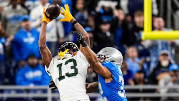 Green Bay Packers wide receiver Dontayvion Wicks (13) makes a catch against Detroit Lions safety Brian Branch (32)
