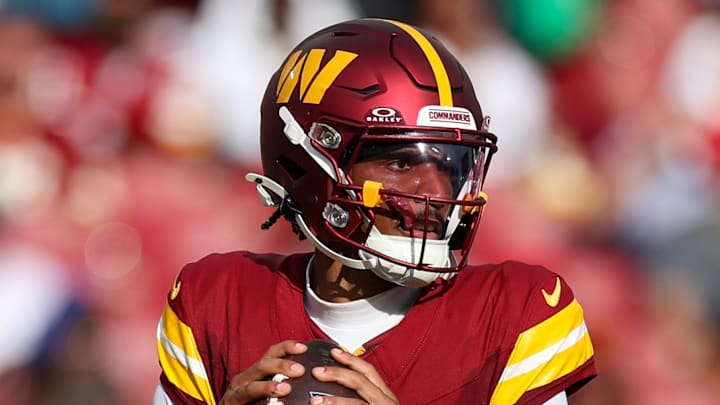 Sep 8, 2024; Tampa, Florida, USA; Washington Commanders quarterback Jayden Daniels (5) drops back to pass against the Tampa Bay Buccaneers in the third quarter at Raymond James Stadium. Mandatory Credit: Nathan Ray Seebeck-Imagn Images