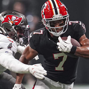 Joe Tryon-Shoyinka attempts to bring down Bijan Robinson of the Falcons. Tryon-Shoyinka was a Tampa Bay first-round pick who was just watching in Cleveland and the Bears need pressure from him on the QB.