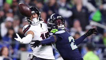Oct 20, 2025; Seattle, Washington, USA; Seattle Seahawks cornerback Riq Woolen (27) defends a pass intended for Houston Texans wide receiver Xavier Hutchinson (19) during the fourth quarter at Lumen Field. Mandatory Credit: Kevin Ng-Imagn Images
