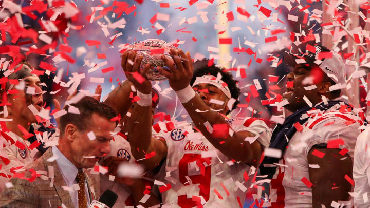 Dec 30, 2023; Atlanta, GA, USA; Mississippi Rebels wide receiver Tre Harris (9) holds up the Peach Bowl trophy after a victory against the Penn State Nittany Lions at Mercedes-Benz Stadium. Mandatory Credit: Brett Davis-USA TODAY Sports