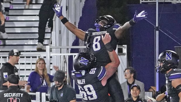 Northwestern Wildcats wide receiver A.J. Henning (8) celebrates his touchdown with offensive lineman Jack Bailey (69) against