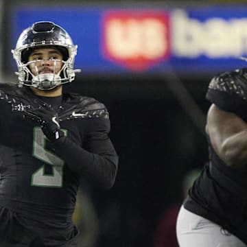 Nov 30, 2024; Eugene, Oregon, USA; Oregon Ducks quarterback Dante Moore (5) throws a pass during the second half against the Washington Huskies at Autzen Stadium. Mandatory Credit: Troy Wayrynen-Imagn Images