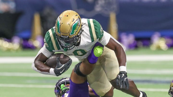 DeSoto's Myson Cook Johnson lunges for extra yardage during a 2024 game at the Alamodome in San Antonio, Texas.