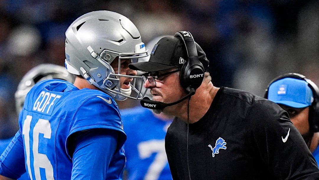 Detroit Lions quarterback Jared Goff (16) talks to head coach Dan Campbell before a play against Green Bay Packers 