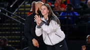 Indiana Fever guard Caitlin Clark cheers from the bench in the first quarter against the Washington Mystics.