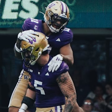 Alphonzo Tuputala (11), shown jumping on Zach Durfee's back, is one of four locals who will start the Apple Cup for the UW. 