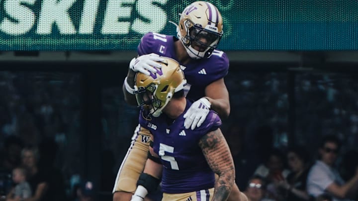 Alphonzo Tuputala (11), shown jumping on Zach Durfee's back, is one of four locals who will start the Apple Cup for the UW. 