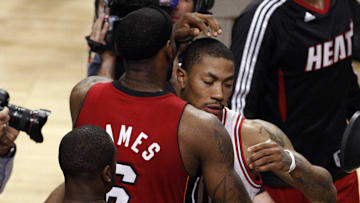 May 26, 2011; Chicago, IL, USA; Miami Heat guard Dwyane Wade (3) watches as forward LeBron James (6) hugs Chicago Bulls guard Derrick Rose (right) after game five of the eastern conference finals of the 2011 NBA playoffs at the United Center. The Heat won 83-80.  Mandatory Credit: Jerry Lai-Imagn Images